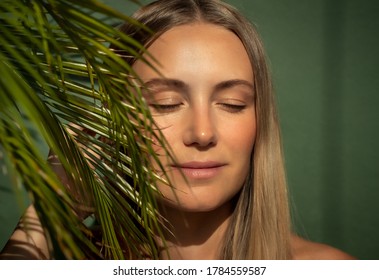 Portrait of a Beautiful Young Woman with Closed Eyes. Nice Female on the Beach. Authentic Women's beauty. Natural makeup. Perfect Skin Tan.