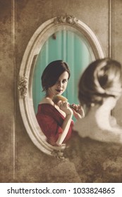 Portrait Of Beautiful Young Woman With Comb Looking At Herself In The Wonderful Mirror. Photo In Old Color Image Style.