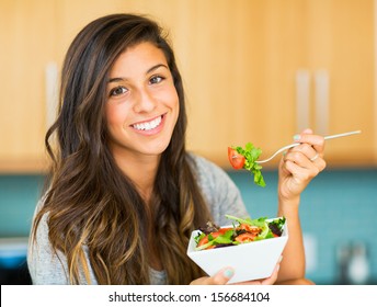 Portrait Of Beautiful Young Woman Eating A Bowl Of Healthy Organic Salad And Smiling