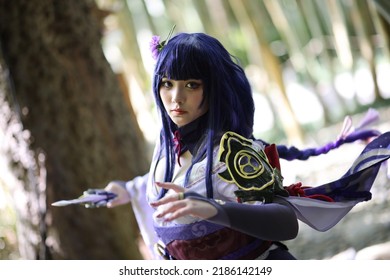 Portrait of a beautiful young woman game cosplay with samurai dress