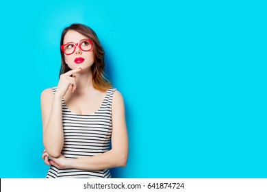 portrait of beautiful young woman in glasses on the wonderful blue studio background - Shutterstock ID 641874724