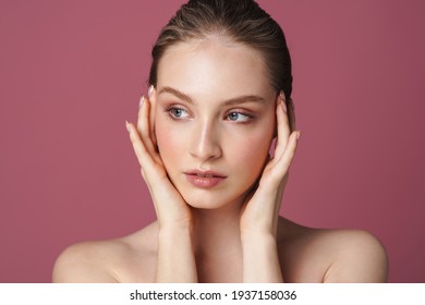 Portrait of beautiful young woman isolated over pink background