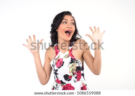Portrait of beautiful young woman joking and making funny face on white background.