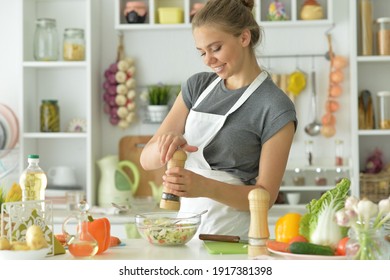 Portrait Of Beautiful Young Woman Making Salad At Home