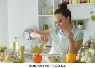 Portrait Of Beautiful Young Woman Making  Salad At Home