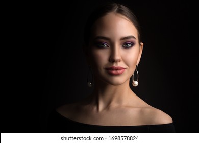 Portrait Of A Beautiful Young Woman On A Black Background. Copycpase