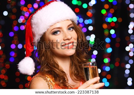Portrait of beautiful young woman on bright lights background
