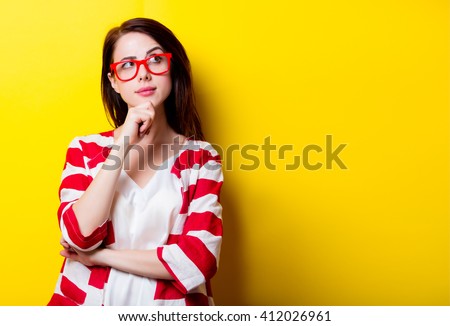 portrait of the beautiful young woman on the yellow background