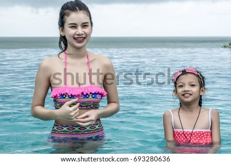 portrait of beautiful young woman in the poolside swimming  during  holiday