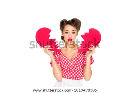 portrait of beautiful young woman in retro clothing with ripped paper heart isolated on white