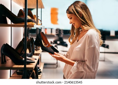 Portrait of beautiful young woman shopping new shoes in store. People shopping concept. - Shutterstock ID 2140613545
