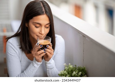 Portrait beautiful young woman smelling coffee - Powered by Shutterstock