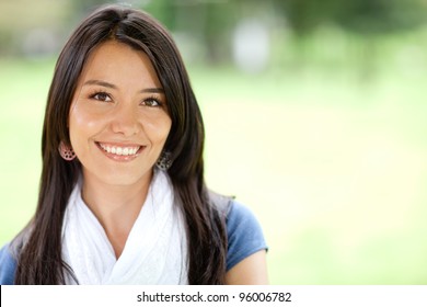 Portrait Of A Beautiful Young Woman Smiling Outdoors