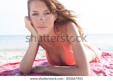 Portrait of beautiful young woman sunbathing on beach, Majorca, Spain
