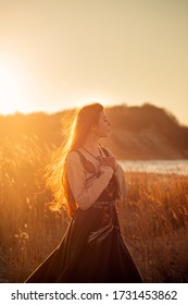 Portrait of beautiful young woman at the sundown lights and rock landscape  - Shutterstock ID 1731453862