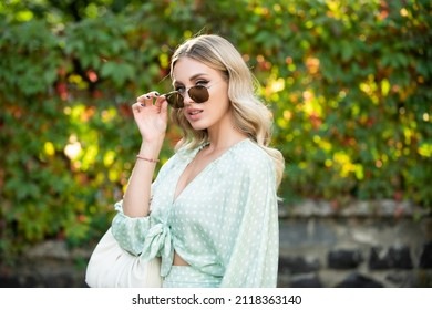 Portrait Of Beautiful Young Woman In Sunglasses. Outdoor Portrait Of A Cute Girl. Happy Cheerful Female Model, Close Up Face.