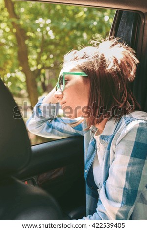 Similar – Two young women resting sitting inside of car