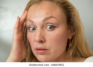 Portrait Of Beautiful Young Woman With Surprised Face. Girl With Freckles And Blonde Hair