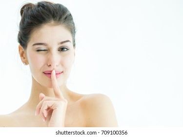 Portrait of beautiful young woman wearing bath cap or bonnet, Beauty Makeup, Woman making silence gesture on white background, Woman with finger on lips asking for silence and quiet, Age 20-30 years.