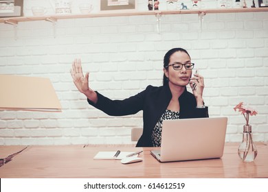 Portrait Of Beautiful Young Woman Working In The Office.Busy Talking On Phone Do Not Disturb.