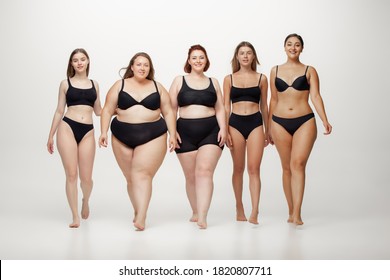 Portrait of beautiful young women with different shapes posing on white background. Happy female models. Concept of body positive, beauty, fashion, style, feminism. Diversity.