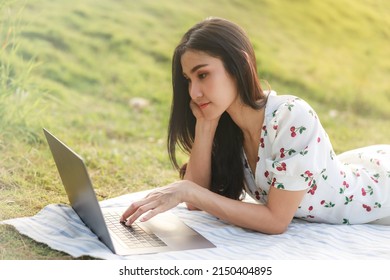 Portrait Of Beautifull Young Asian Woman Freelance Works On Laptop At Outdoor Workspace In The Garden.