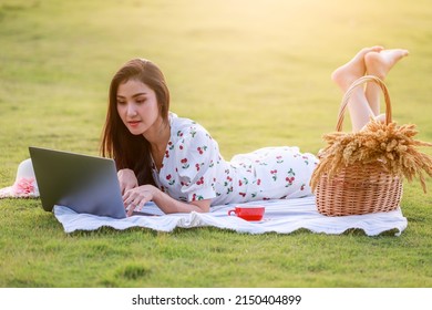 Portrait Of Beautifull Young Asian Woman Freelance Works On Laptop At Outdoor Workspace In The Garden.