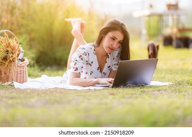 Portrait Of Beautifull Young Asian Woman Freelance Works On Laptop At Outdoor Workspace In The Garden.