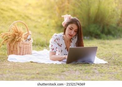 Portrait Of Beautifull Young Asian Woman Freelance Works On Laptop At Outdoor Workspace In The Garden.