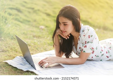 Portrait Of Beautifull Young Asian Woman Freelance Works On Laptop At Outdoor Workspace In The Garden.