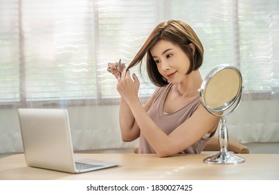 Portrait Of Beauty Asian Woman Has Scissors In Hand Cutting Hair. Girl Have New Hairstyle And Haircut, Do It Yourself In Quarantine Stay Home, New Normal Lifestyle Barber, E-learning Online Concept