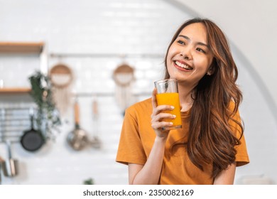 Portrait of beauty body slim healthy asian woman drinking glass of juice and orange.young girl preparing cooking healthy drink with fresh orange juice in kitchen at home.Diet concept.healthy drink - Powered by Shutterstock