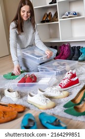 Portrait Beauty Brunette Woman Hold Plastic Box Shoes Storage Organization Posing At Wardrobe Room. Smiling Female Filling Cabinet Tidying Up Seasonal Cleaning Footwear Comfortable Folded In Cupboard