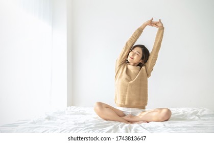Portrait of beauty happy asian sexy woman awaking, wake up on the bed (sleep). Young beautiful asian girl stretching her arms in fresh early morning, relax peaceful morning routine concept banner