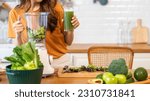 Portrait of beauty healthy asian woman making green vegetables detox clean and green fruit smoothie with blender.young girl drinking glass of green fruit smoothie in kitchen.Diet concept.healthy drink