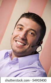 Portrait Of Beauty Male Customer Service Rep With Headset Smiling