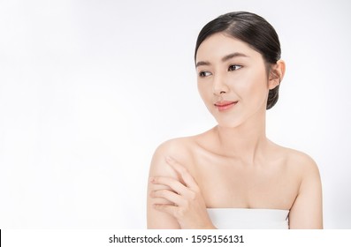 Portrait Of Beauty Smiling Asian Woman Applying Lotion To Her Arm Skin During Her Morning Routine. Cute Asian Girl. Skincare Body Lotion, Beauty Clinic Skincare Spa Indoors Woman Lifestyle Concept