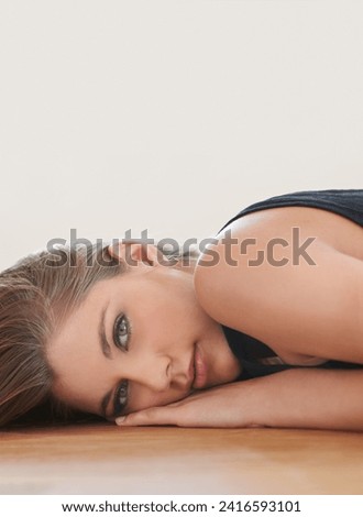 Portrait, beauty or woman on wooden floor in house to relax alone in Switzerland. Natural face, serious person or attractive young girl lying in home, apartment or lounge for skincare on mockup space