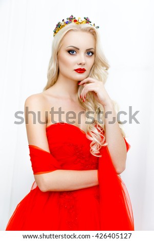Portrait of beauty young queen blond girl with red lips. Female face with clear skin close-up. Skincare