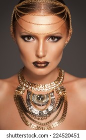 Portrait of a beautyful woman with golden makeup wearing jewelry, Egyptian Style Woman 
