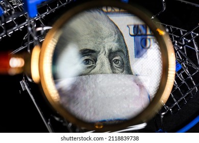 Portrait Of Ben Franklin In Medical Mask On One Hundred Dollar Bill On Background Of Shopping Carts