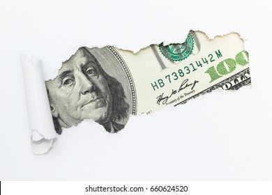 Portrait of Benjamin Franklin on a hundred dollar bill in the gap (hole) of a white background. Dirty money, illegal income. Criminal money.