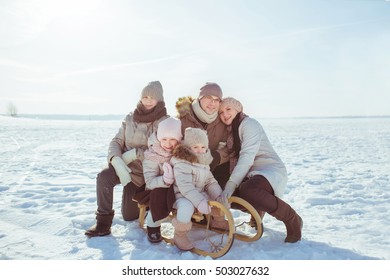 Portrait Of Big Family On A Sledge In Winter