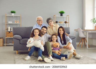 Portrait of a big family spending time together at home. Elderly grandparents, young parents and children are having a happy time. Big happy family of different generations - Powered by Shutterstock