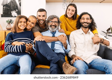 Portrait of big multi generational happy family. Photo group of grandfather, mother, father, aunt, ancle and granddaughter sitting together on sofa at home - Powered by Shutterstock