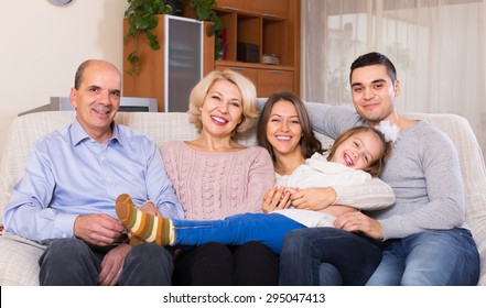 Portrait Of Big Smiling Multigenerational Family On Sofa In Living Room
