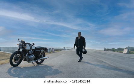 Portrait Of Biker And Motorcyclist On The Highway