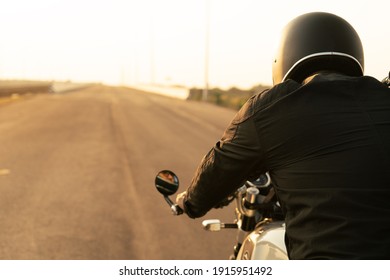 Portrait Of Biker And Motorcyclist On The Highway