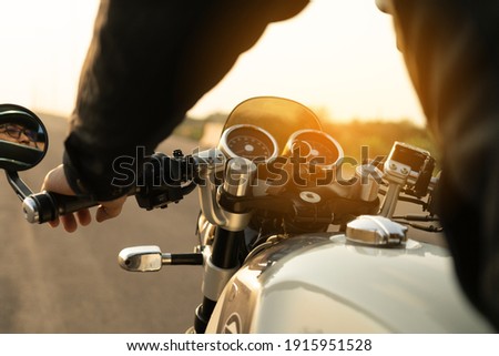 Similar – Senior man steering motorcycle on road