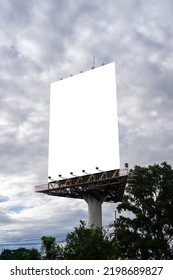 Portrait Billboard White Blank For Outdoor Advertising At Blue Sky.